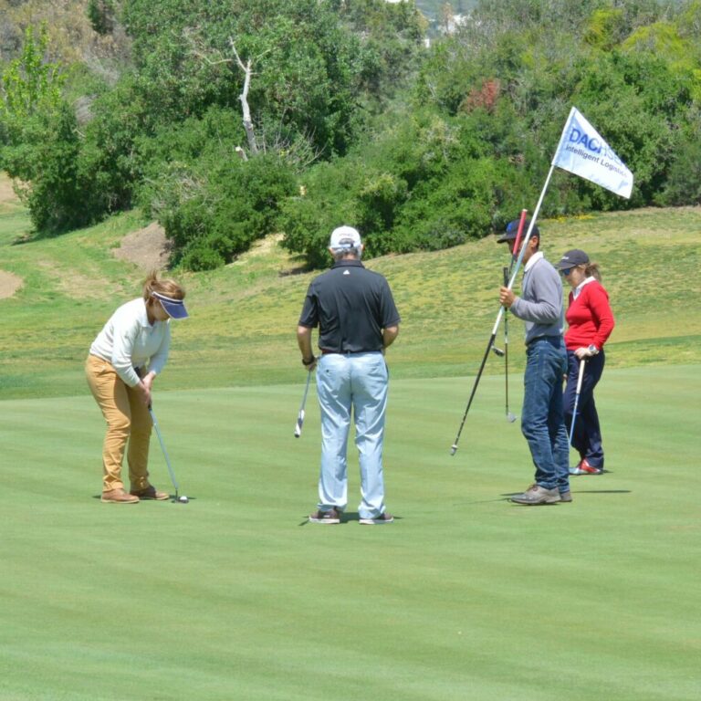 A group of people playing a round of golf